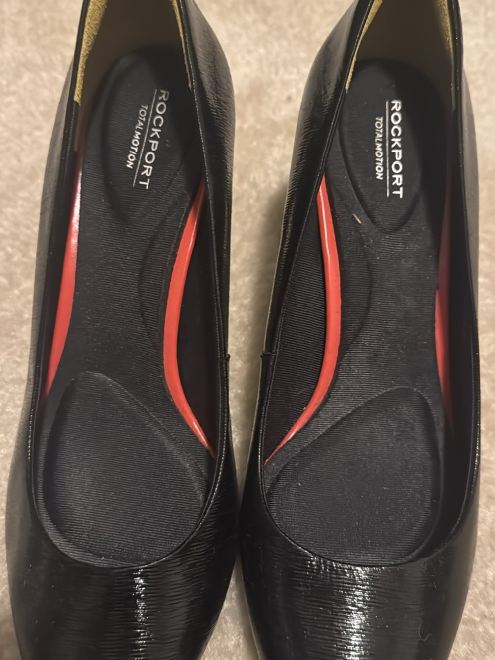Comfortable Rockport Total Motion pumps in black textured leather